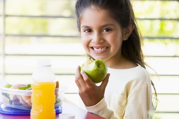 Girl eating lunch at kindergarten