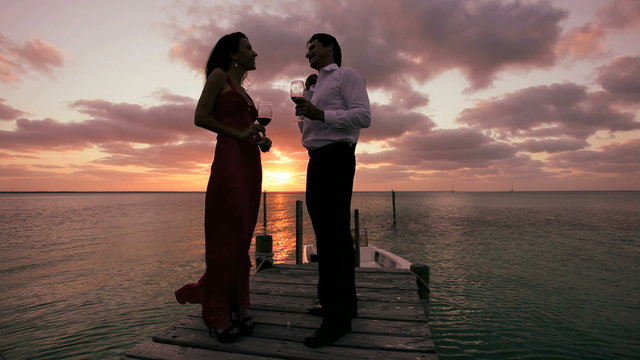 Elegant Couple at Sunset with a Glass of Wine