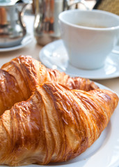 Breakfast with coffee and croissants
