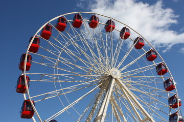 Red Carriages on a Large Fun Fair Big Wheel.