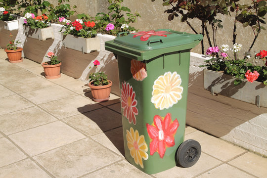 Trashcan in yard , with flower painting