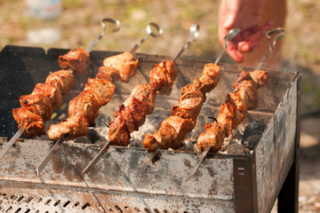 Grilling shish kebabin in brazier