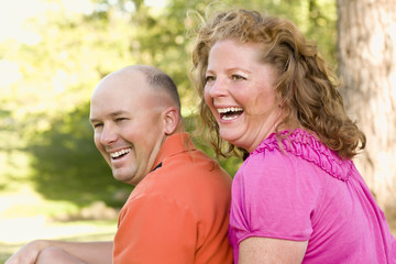 Obraz premium Happy Attractive Couple Laughing in Park