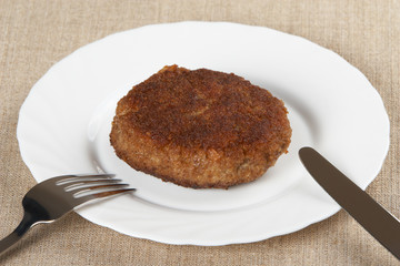 Roast cutlet on a white plate