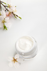 Fototapeta na wymiar Face cream and almond flowers