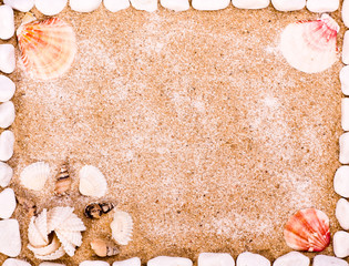 Sea shells and stones frame on sand