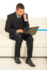 Business man using laptop and cellphone