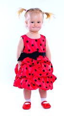 Cute little girl in a red dress. In the studio. Isolated