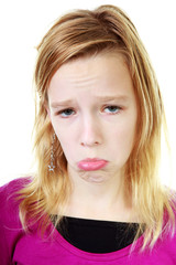 Naklejka premium Girl makes sad face over white background