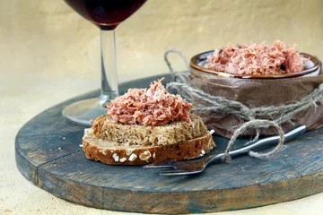 Zelfklevend Fotobehang pate of duck meat Rillettes de Canard  with a glass of wine © Olga Kriger