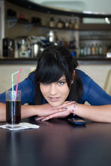 A teenage girl in the bar