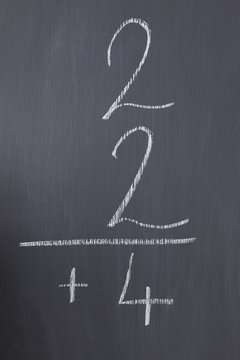 Blackboard with a simple fraction written on it