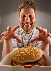 Happy man preparing to eat burger