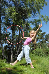 Little girl having fun with hula hoop