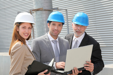 Business people meeting on industrial site