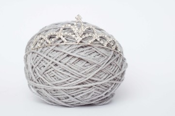 Grey ball of yarn with a tiara