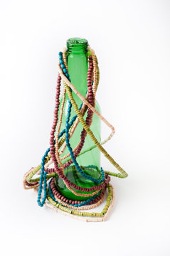 Green bottle decorated with colour beads