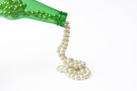 Pouring pearls from a bottle