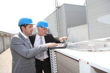 Businessmen on industrial site