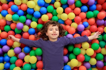 Fototapeta na wymiar kolorowe kulki śmieszne parku dziewczynka leżącego gestykuluje