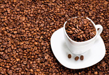 White cup filled with coffee beans