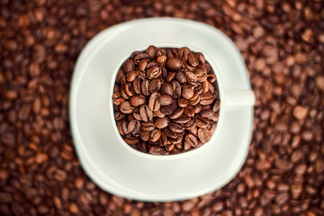 White cup filled with coffee beans