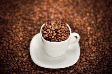 White cup filled with coffee beans