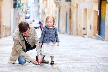 Father and daughter outdoors in city