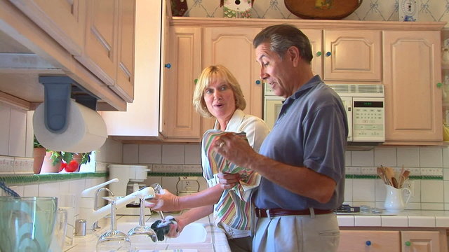 Mature couple doing dishes