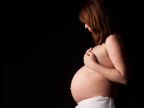 beautiful pregnant woman on black