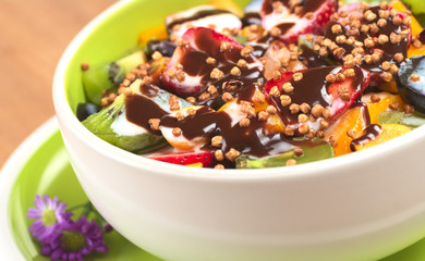 Fresh fruit salad with plain yoghurt and chocolate syrup