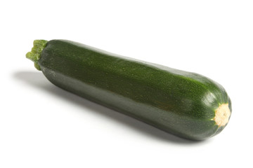 Courgette or zucchini, angled and isolated on white.