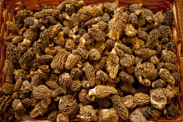 Morel mushrooms bunched together in a rattan basket