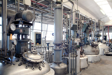 internal of a chemistry factory with tanks and pipes