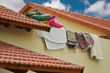 pillows and rugs lie on the tiled roof