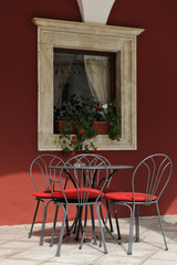 Empty metallic chairs on a cafe terrace in Sibenik