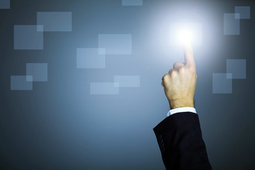 hand pushing a button on a touch screen interface