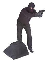 robber with sack aiming with his gun