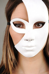 Portrait of a beautiful girl with white mask