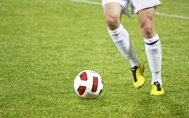 Soccer player running after the ball