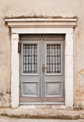 Fototapeta na wymiar Gray wooden doors in Rijeka, mediterranean town on coast of Croa