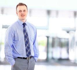 Portrait of a happy young businessman, smiling, indoor