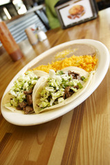 Steak tacos with rice and beans at a taqueria