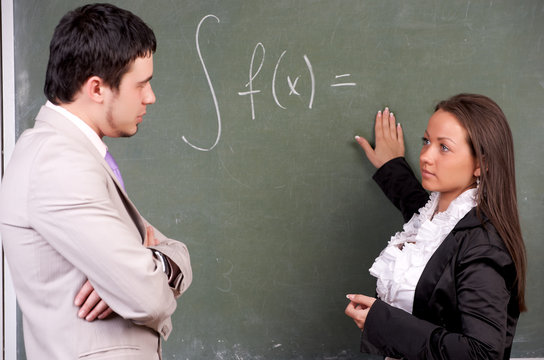 Young Teacher And Student In A Classroom