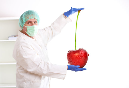 Researcher holding up a GMO fruit