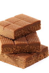 Toffee in plate on white background