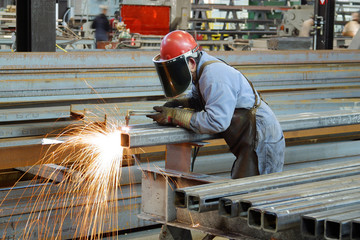 Steel Worker cutting with acetylene torch