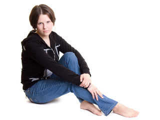 A woman sits a white background.