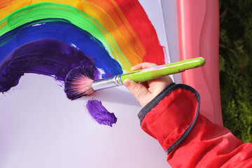 Child painting rainbow
