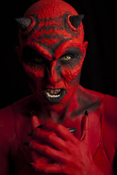 Red devil woman. Low key lighting.